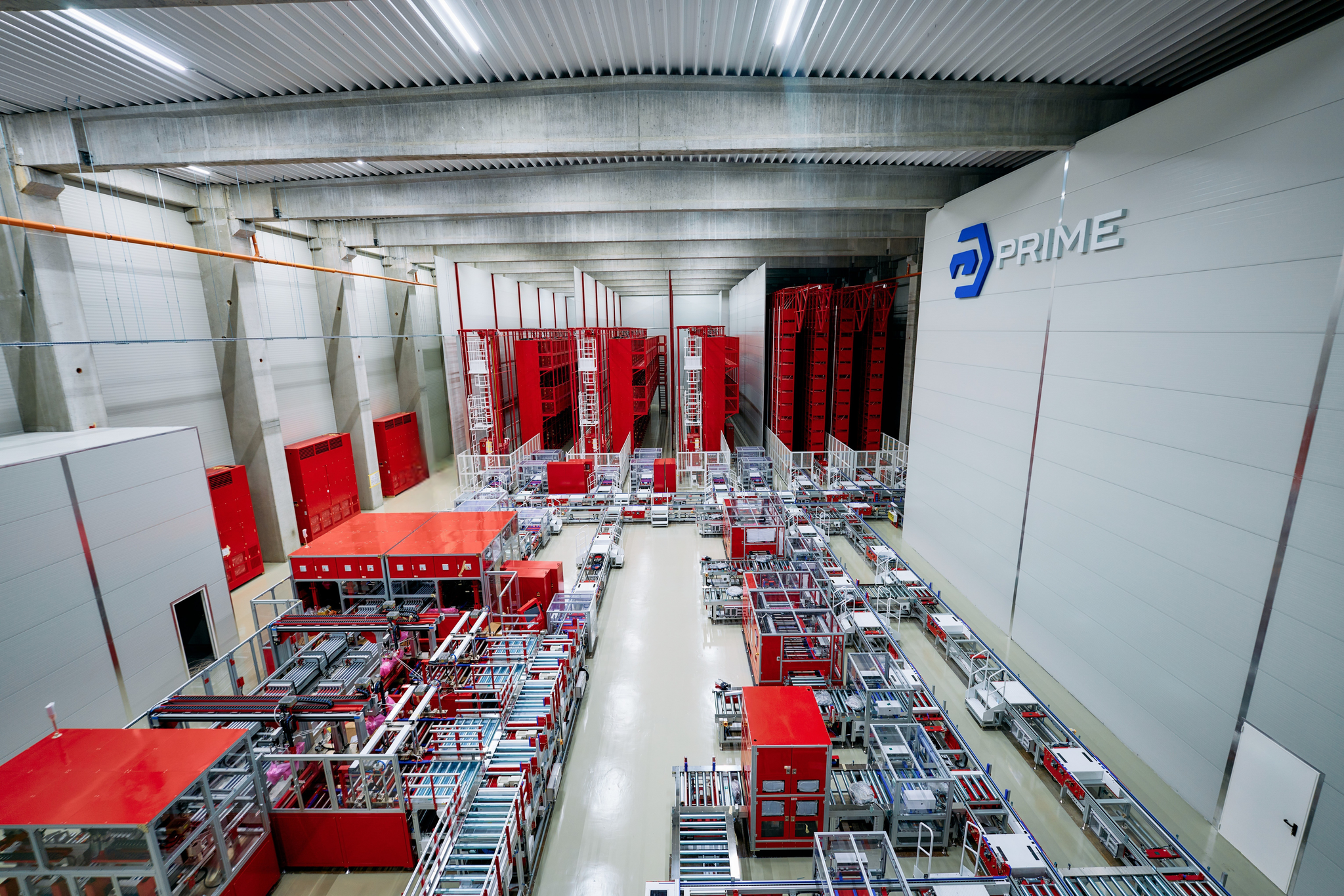 Aerial view of Prime Batteries Gigafactory interior showing production lines and red machinery